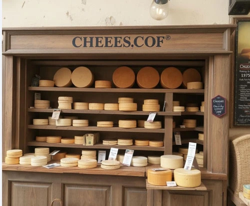 cheeses on the shelf in the shop
